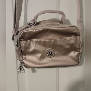 Kipling Compact crossbody bag in a metallic beige or champagne